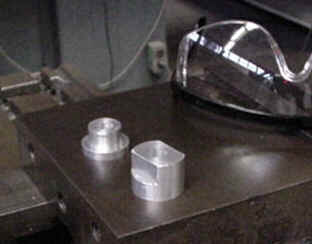 Aluminum blocks receive axle.